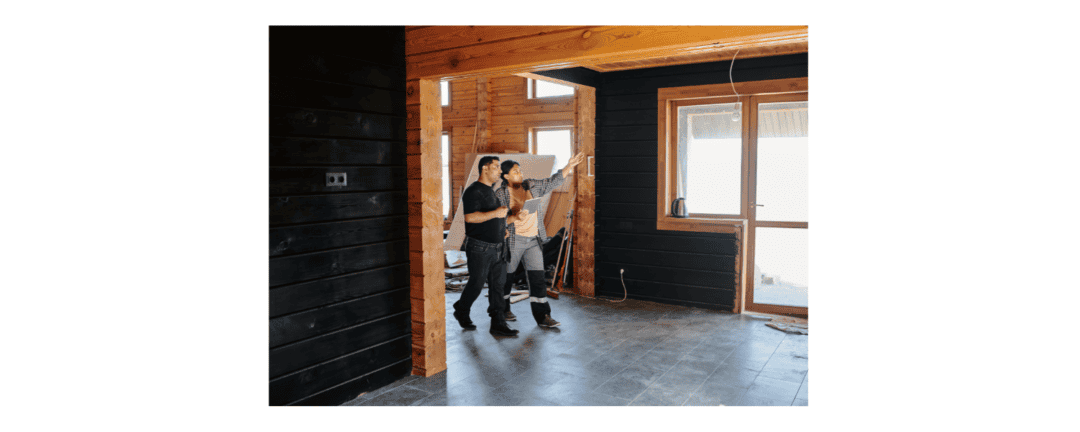 2 people looking at a room with window talking about how to renovate the room
